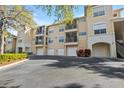 Multi-story condominium building with private garages and screened lanais offering covered parking spaces at 5125 Palm Springs Blvd # 11306, Tampa, FL 33647