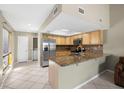 Updated kitchen featuring stainless steel appliances, granite countertops, and ample storage space at 6262 142Nd N Ave # 1304, Clearwater, FL 33760