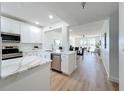 Modern kitchen boasts white cabinets, stainless steel appliances, and an open layout to the dining and living area at 7862 Sailboat Key S Blvd # 103, South Pasadena, FL 33707
