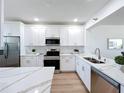 Bright kitchen featuring white cabinets, stainless steel appliances, and quartz countertops at 7862 Sailboat Key S Blvd # 103, South Pasadena, FL 33707