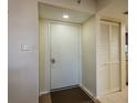 Entryway showcasing a secure front door, neutral walls, and a coat closet for convenient storage at 9860 62Nd N Ter # 1051, St Petersburg, FL 33708
