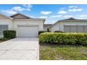 Charming single-story villa showcasing a well-maintained exterior, driveway, and manicured landscaping at 1120 Radison Ave # 6, Sun City Center, FL 33573