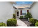 Inviting front entrance with manicured landscaping and walkway leading to the front door at 1120 Radison Ave # 6, Sun City Center, FL 33573