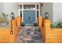 Inviting entrance features stone steps, craftsman lights, and modern wood planters at 1320 Coral S Way, St Petersburg, FL 33705