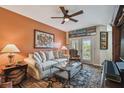 Cozy living room with a plush sofa, glass coffee table, and decorative accents with a ceiling fan at 2010 E Palm Ave # 15210, Tampa, FL 33605