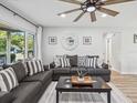 Inviting living room featuring modern decor, comfortable seating, and a ceiling fan at 2028 Pine Ridge Dr, Clearwater, FL 33763