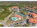Beautiful aerial view of a community featuring tennis courts, a pool, and boat docks at 234 Mariner Dr # 234, Tarpon Springs, FL 34689