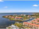 Stunning waterfront community with a marina and lovely homes with red tiled roofs on a sunny day at 234 Mariner Dr # 234, Tarpon Springs, FL 34689