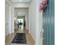 Welcoming foyer with light hardwood floors and a view into the open living space at 2516 Leafwing Ct, Palm Harbor, FL 34683