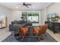 Cozy living room with a large sectional sofa and sliding doors to the patio at 2516 Leafwing Ct, Palm Harbor, FL 34683