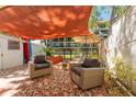 Relaxing outdoor patio with comfortable chairs and a shade sail at 2700 Bayshore Blvd # 512, Dunedin, FL 34698