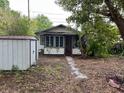 Charming single-Gathering home featuring a red door, a shed, and large windows at 3029 20Th St, St Petersburg, FL 33713