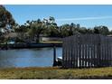 A calm waterway view with a wooden fence, highlighting the property's access to water activities at 4005 Sunrise S Dr, St Petersburg, FL 33705