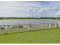 Backyard view with expansive lake and green grass at 5210 Dandelion St, Apollo Beach, FL 33572