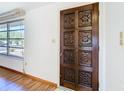 Detailed shot of a carved, decorative wood front door at 7330 Cherry Laurel Dr, Port Richey, FL 34668