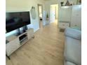 Open-concept living room with modern furniture, hardwood floors, and a view into other rooms at 801 53Rd N Ter, St Petersburg, FL 33703