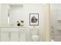 Bright bathroom featuring a single sink vanity with modern cabinets, art, and a shower with curtain at 10236 Gentle Rain Dr, Land O Lakes, FL 34638