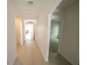 Bright hallway with tile flooring, archways, and doors to various rooms at 11517 Koti Creek Ln, Thonotosassa, FL 33592
