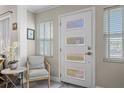 Bright entryway featuring a modern door with glass panels and a cozy seating area at 145 38Th Ne Ave, St Petersburg, FL 33704