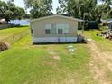Side view of the home and lawn showcasing the home's exterior and a well-kept yard at 14620 Geneva Dr, Odessa, FL 33556