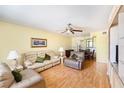 Cozy living room with hardwood floors, ceiling fan and comfortable seating area next to dining table at 1900 59Th N Ave # 217, St Petersburg, FL 33714