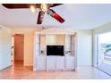 Open living area with entertainment center, ceiling fan, and access to balcony offering lots of natural light at 1900 59Th N Ave # 217, St Petersburg, FL 33714