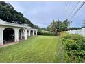 Spacious backyard with well-maintained lawn, patio, privacy landscaping, and lush greenery at 2114 Indian N Ave, Belleair Bluffs, FL 33770