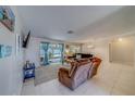 Comfortable living room with tile flooring, lots of natural light, and ample space for furniture at 2269 Beverly Ln, Clearwater, FL 33764