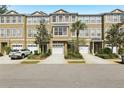 Charming townhome with attached garage, well-maintained landscaping, and a welcoming facade at 3005 Bayshore Pointe Dr, Tampa, FL 33611