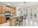 Well-lit kitchen featuring granite countertops, stainless steel appliances, and bar seating at 3005 Bayshore Pointe Dr, Tampa, FL 33611