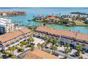 Coastal townhomes featuring manicured grounds, private garages, and breathtaking waterfront views and boat docks at 301 Madeira Cir, Tierra Verde, FL 33715
