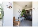 Inviting front porch featuring tiled floors, a cozy bench, and stylish décor, perfect for relaxing at 301 Madeira Cir, Tierra Verde, FL 33715