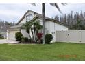 Charming single Gathering home with mature palm trees and manicured lawn at 30829 Iverson Dr, Wesley Chapel, FL 33543