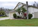 Charming single Gathering home with mature palm trees and manicured lawn at 30829 Iverson Dr, Wesley Chapel, FL 33543