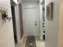 Bright foyer featuring a striking brick accent wall and neutral tile flooring at 601 N Hercules Ave # 403, Clearwater, FL 33765