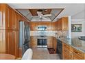 Well-equipped kitchen with stainless steel appliances and wooden cabinets at 6158 Palma Del Mar S Blvd # 406, St Petersburg, FL 33715