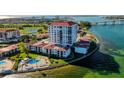 Scenic aerial view of waterfront condos boasting community pool, lush landscaping, and coastal charm at 6265 Sun Blvd # 806, St Petersburg, FL 33715