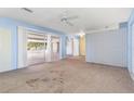 Spacious living room with a brick accent wall and sliding glass doors to a sunroom at 6549 19Th N St, St Petersburg, FL 33702