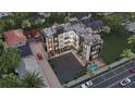 Aerial view of the modern building, showing the pool, rooftop terrace, and surrounding neighborhood at 702 Pass A Grille Way, St Pete Beach, FL 33706