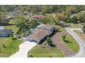 Sprawling property featuring a private pool, brick driveway, and lush green landscaping at 7922 Spring Valley Dr, Tampa, FL 33615