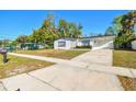Well-maintained single-story home with a neat front lawn and a spacious carport area at 8003 W Powhatan Ave, Tampa, FL 33615