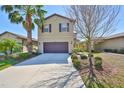 Inviting two-story home with a neatly landscaped front yard and attached two-car garage at 8306 Red Spruce Ave, Riverview, FL 33578