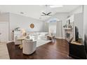 Bright living room with vaulted ceilings, skylights, hardwood floors, a fireplace, and lots of natural light at 954 Cobblestone Ln, Tarpon Springs, FL 34688