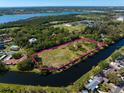 Spacious property on the water surrounded by lush trees offering a serene and private homesite near local lakes at 9554 90Th Ave, Seminole, FL 33777