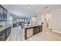 Open-concept kitchen with stainless steel appliances and a large center island at 10072 Sage Creek Dr, Ruskin, FL 33573