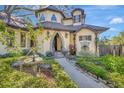 Picturesque home showcasing a stone archway, a water fountain, and lovely landscaping around the entrance at 1108 W Charter St, Tampa, FL 33602