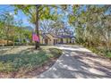 Charming home with a circular driveway, a well-manicured lawn, and an American flag flying proudly at 1108 W Charter St, Tampa, FL 33602