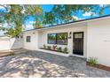 Inviting home showcasing black trim windows, a new front door, and a fresh exterior paint at 1600 Connecticut Ne Ave, St Petersburg, FL 33703