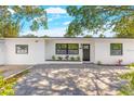 Beautiful home featuring a new paved driveway, fresh exterior paint, and a modern front door at 1600 Connecticut Ne Ave, St Petersburg, FL 33703
