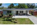 Single-story home boasts a lovely front yard, stylish walkway, and a convenient attached carport at 1623 San Mateo Dr, Dunedin, FL 34698